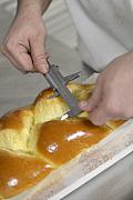 Mains utilisant un pied à coulisse pour mesurer une brioche tressée dans une unité de production agroalimentaire.